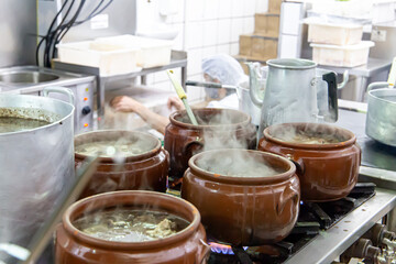 Ceramic pot with feijoada, typical Brazilian food. In a restaurant in Brazil