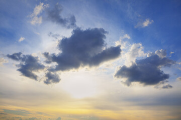 Sunset with dark clouds on the blue sky 