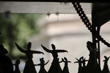 Small trinket and sculpture of sufism and whirling dervish silhouette in street sellers infront of the tomb of sems-i tebrizi tomb in Konya.
