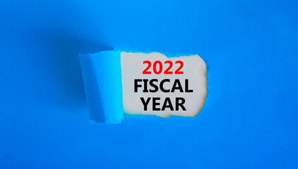 2022 fiscal new year symbol. Words '2022 fiscal year' appearing behind torn blue paper. Beautiful blue background. Business, 2022 fiscal new year concept, copy space.