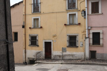 Fototapeta na wymiar Pale Yellow and Pink House Facades in Rural Village, Central Italy