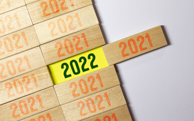 Merry Christmas and happy new year concept, Flipping of wooden cube block change from 2021 to 2022