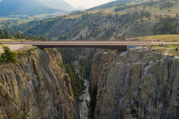 mountain canyon and river with bridge crossing