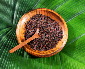 Raw organic brown mustard seeds in a bowl