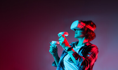 Caucasian woman wearing virtual reality headset and gesturing in neon light.