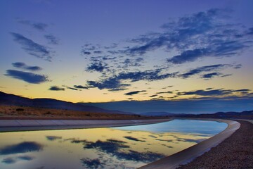 Sunset at The California Aqueduct With Mountain Background  - obrazy, fototapety, plakaty