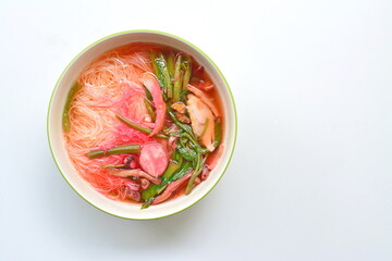 White noodles, meatball noodles, fish, shredded vegetables in a bowl on a white background, top view
