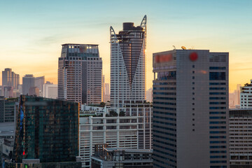 Fototapeta na wymiar Aerial view modern office buildings in Bangkok city downtown with sunset time