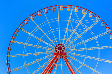 Big ferris wheel against the blue sky