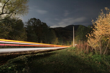 ray of light by car at night road