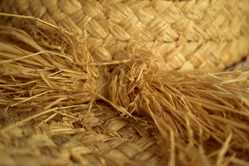 close-up of old worn straw hat with a bow