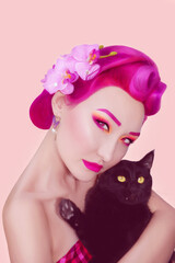 Naklejka premium Portrait of a girl with black cat in pin up style