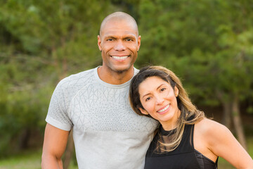 Portrait of fitness couple hugging and looking at camera