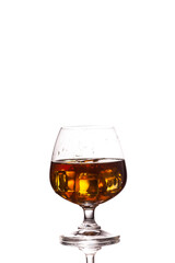 Scotch whiskey with ice in glass on table white background