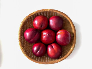 Sweet red nectarines in a bamboo basket