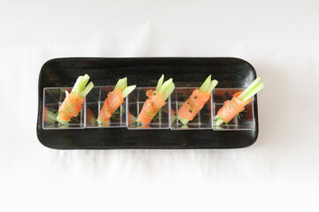 raw smoked salmon fish seafood wrapped with vegetable in cup canapés in white background Christmas festival menu