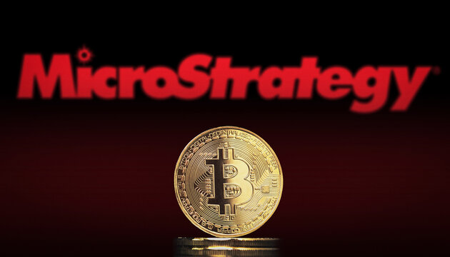 Cali, Colombia - July 20, 2021: Bitcoin BTC representation coin with MicroStrategy logo in background.