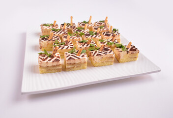 mini coffee tiramisu pastry cream cake dessert on party tray in white background for Christmas festival menu