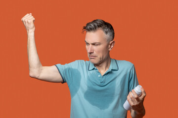 Man in wet tshirt with body deodorant