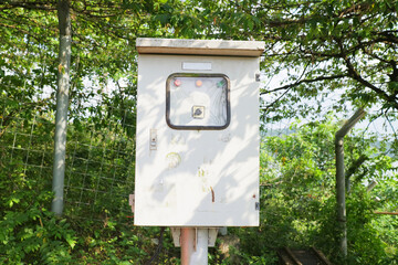 white electric box on the side of the road