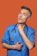 Attentive male doctor touching his neck