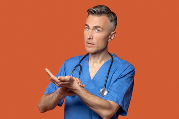 Man with stethoscope listening to his pulse