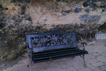 black iron chair under the rock cliff