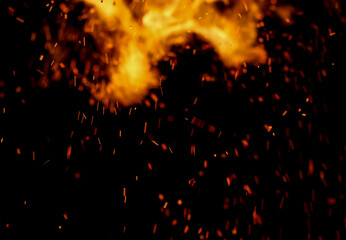 Fototapeta na wymiar fire flame with sparks on black background
