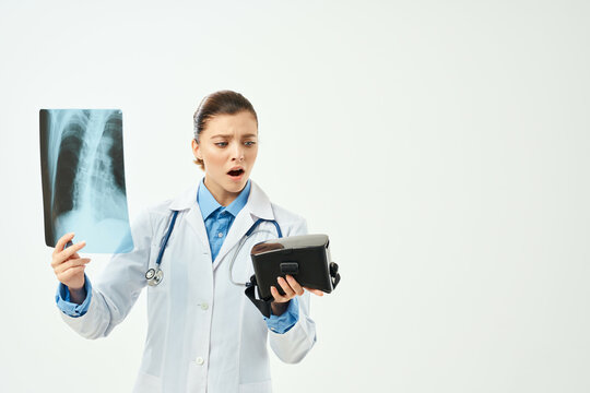 female doctor in white coat x-ray virtual reality glasses technology hospital