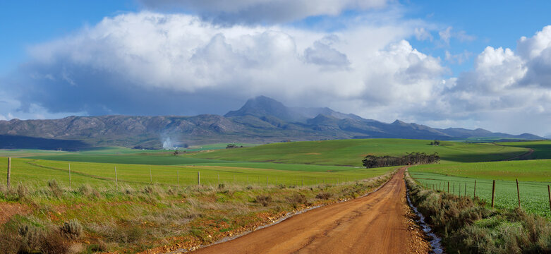 Rural scenery near Caledon with views across farm land towards Babilonstoring or Babylonstoren in the rain. Overberg. Western Cape. South Africa