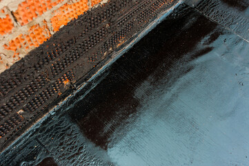 black insulation of a new monolithic house with a large plan


