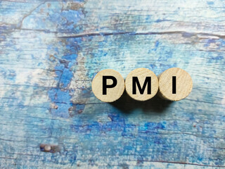 Business concept.Word PMI writing on block cylinder on a wooden background.
