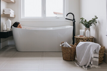 Women enjoying bath in luxury bathroom with bath