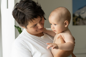 picture of happy mother with baby in hands