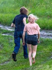 People in the rain on a dirt road