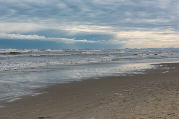 Winter seashore with clouds and waves