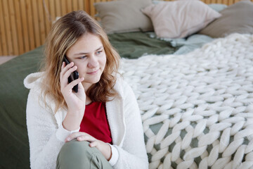 Teenage girl with smartphone at home