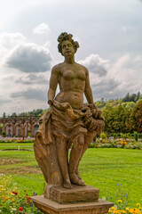 Stone sculpture of a naked woman in the park.