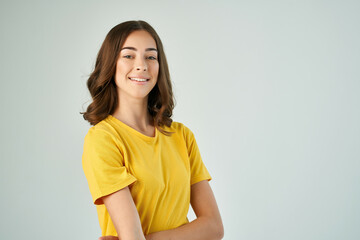 cheerful brunette in yellow t-shirt fashion hairstyle glamor cropped view studio