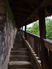 Diminishing perspective of historic passage Seilergang in Esslingen am Neckar, Baden-W&uuml;rttemberg, Germany connecting town center with the castle on the hill with stone stairs and wooden railing.
