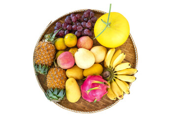 Mixed fruits in bamboo trays on white background, to be prepared in various ceremonies. Buddhist religion, consisting of pineapple, apple, grape, dragon fruit, orange, mango, banana, cantaloupe, pear