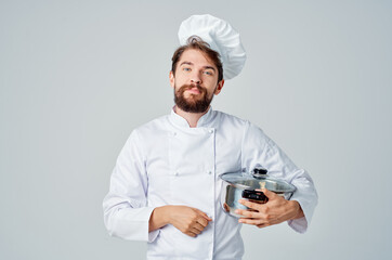 male chef with a saucepan in his hands cooking food kitchen lifestyle