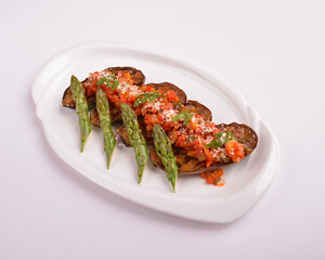 baked bbq eggplant with chef homemade salsa sauce and asparagus in white background for Christmas festival menu