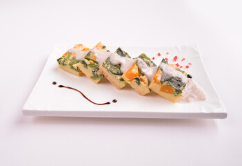 steamed egg pudding with pumpkin and vegetables with white coconut sauce in white background for Christmas festival menu