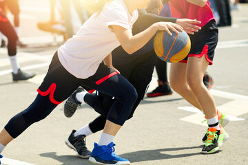 Fototapeta premium Girls play street basketball