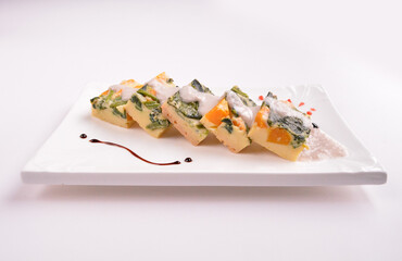 steamed egg pudding with pumpkin and vegetables with white coconut sauce in white background for Christmas festival menu