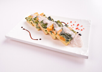steamed egg pudding with pumpkin and vegetables with white coconut sauce in white background for Christmas festival menu
