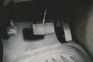 Old retro gas pedals and brakes in a car.