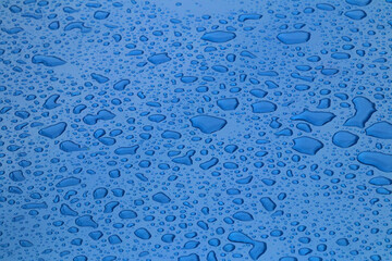 Drops of water on blue surface 
