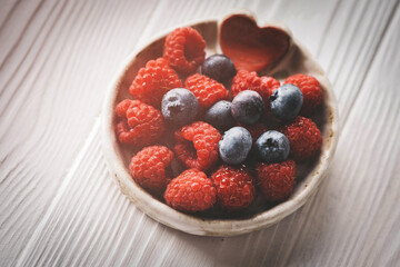 blueberries in a small ceramic bowl with a red heart decor
